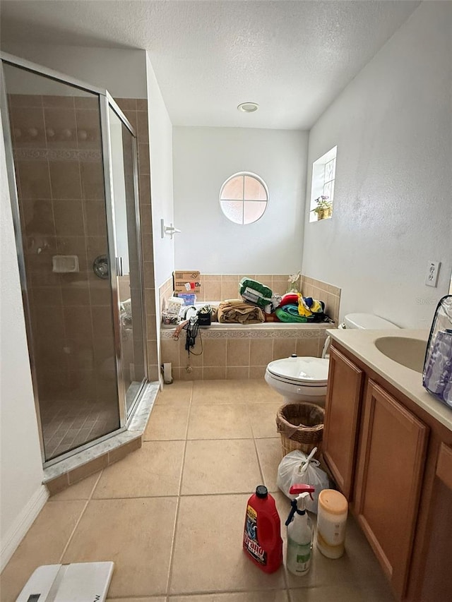 bathroom with toilet, a stall shower, vanity, a textured ceiling, and tile patterned floors