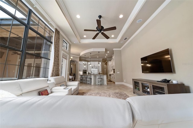 bedroom with visible vents, arched walkways, a raised ceiling, crown molding, and recessed lighting