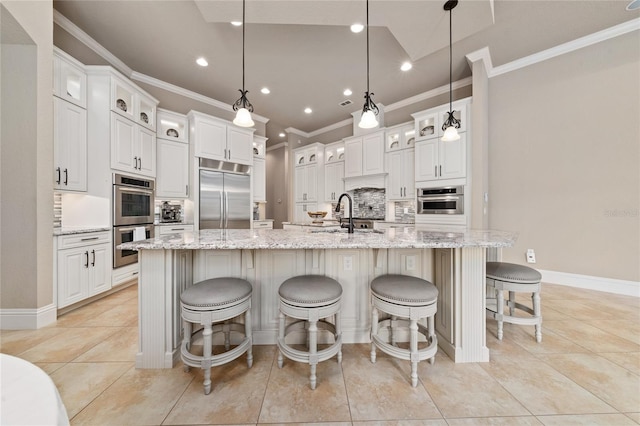 kitchen featuring appliances with stainless steel finishes, a spacious island, and decorative light fixtures