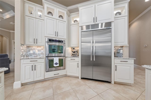 kitchen with appliances with stainless steel finishes and white cabinets