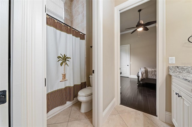 full bathroom with toilet, a ceiling fan, vanity, baseboards, and tile patterned floors