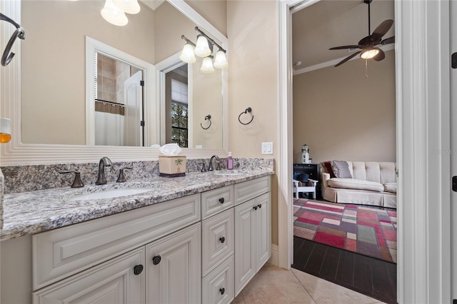 bathroom with crown molding, tile patterned floors, a sink, and double vanity