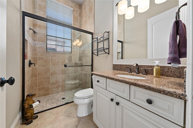 full bathroom featuring toilet, a shower stall, vanity, and tile patterned floors