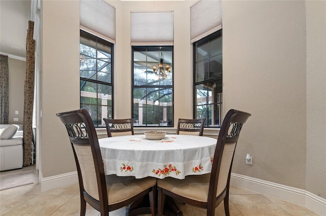 dining room featuring light tile patterned flooring, a wealth of natural light, and baseboards