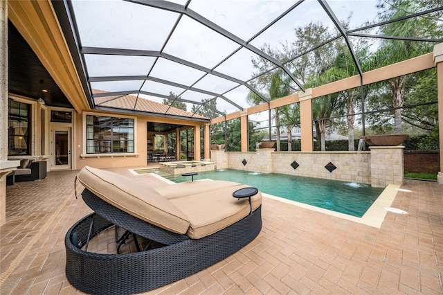 view of swimming pool with a lanai, a patio area, and a pool with connected hot tub