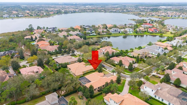 birds eye view of property with a water view and a residential view