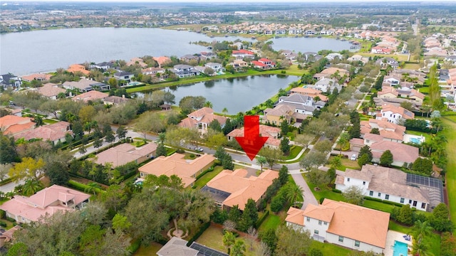 birds eye view of property with a water view and a residential view