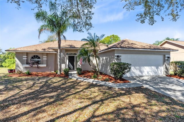 ranch-style home featuring a garage, driveway, and stucco siding