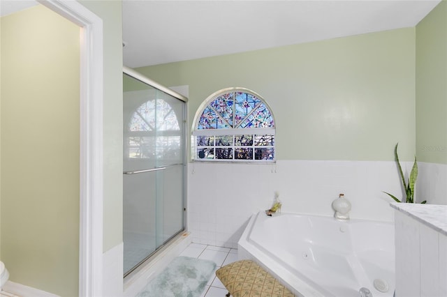 4222 Gold Rush Ln, Saint Cloud, FL 34772 - bathroom featuring a whirlpool tub, tile patterned flooring, and a shower stall