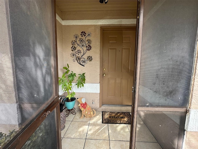 view of exterior entry featuring stucco siding