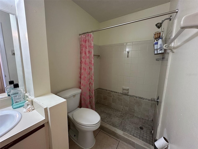 full bathroom featuring vanity, a shower stall, toilet, and tile patterned floors