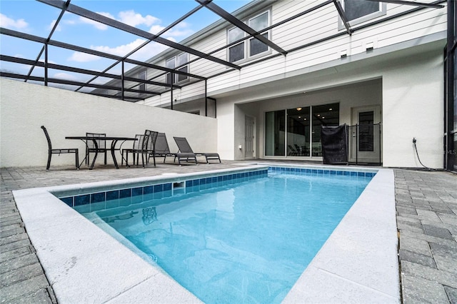 pool featuring a lanai and a patio area