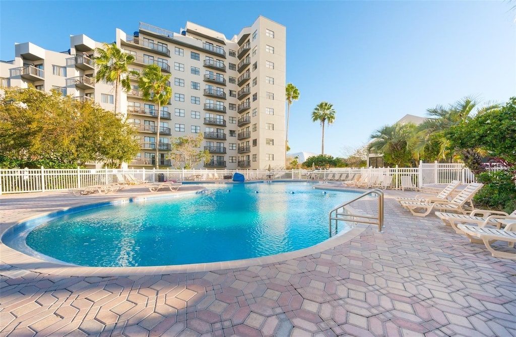 6165 Carrier Dr Unit 1501, Orlando, FL 32819 - community pool featuring a patio area and fence