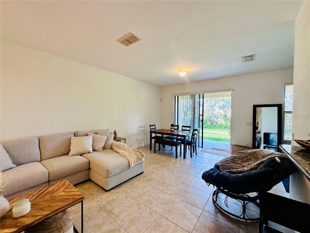 living room with visible vents and light tile patterned floors