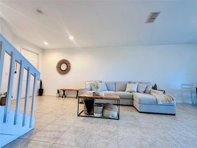 living area with light tile patterned floors, baseboards, visible vents, and recessed lighting