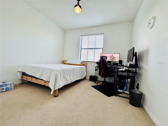 carpeted bedroom featuring baseboards