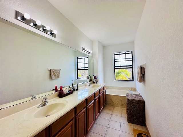 full bath featuring double vanity, a garden tub, a sink, and tile patterned floors