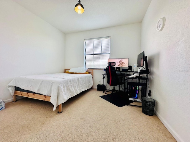 carpeted bedroom featuring baseboards