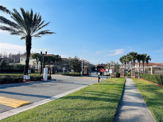 view of street with traffic signs, curbs, sidewalks, and street lights