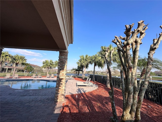 community pool featuring a patio area and fence