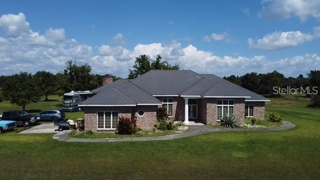 view of front of property with a chimney and a front yard