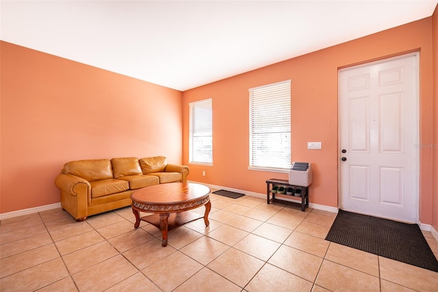 living area with light tile patterned floors and baseboards