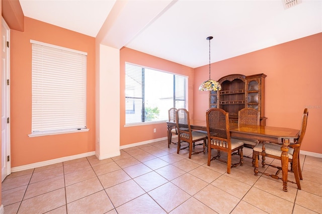 dining room featuring light tile patterned floors, visible vents, and baseboards