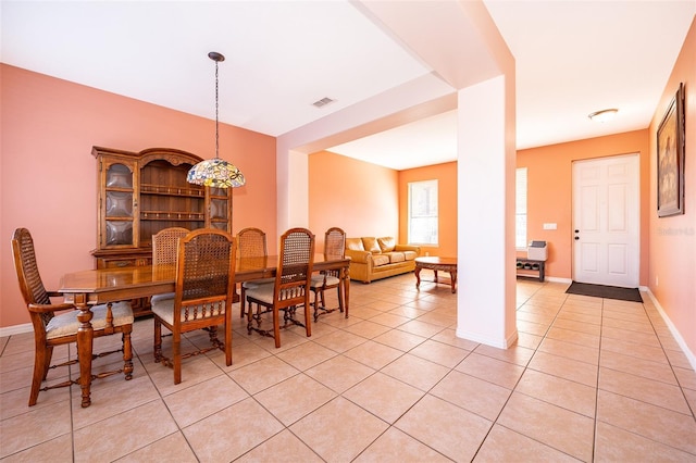 dining room with baseboards, decorative columns, visible vents, and light tile patterned flooring