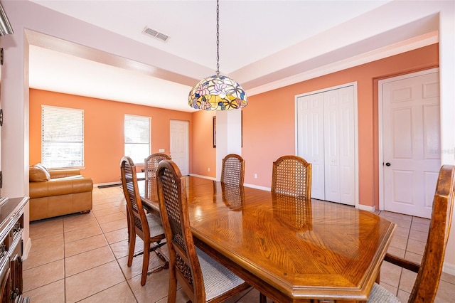 dining room featuring light tile patterned floors, baseboards, visible vents, and a raised ceiling