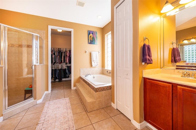 full bath featuring a stall shower, visible vents, tile patterned floors, a garden tub, and vanity