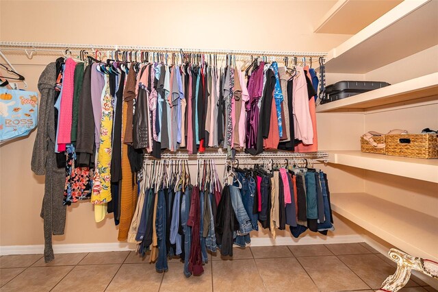 walk in closet with tile patterned floors