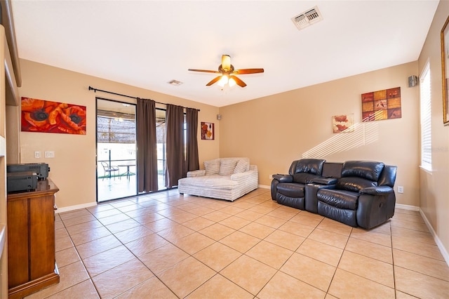 living area featuring visible vents, ceiling fan, baseboards, and light tile patterned floors