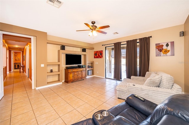 living area featuring visible vents, ceiling fan, baseboards, and light tile patterned floors