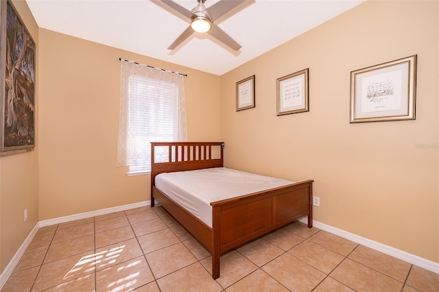 bedroom with light tile patterned floors, baseboards, and a ceiling fan