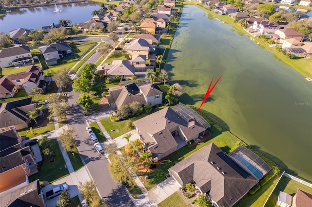 birds eye view of property with a water view and a residential view