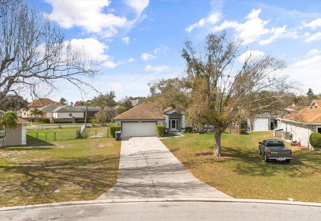 view of front of property featuring a garage, fence, a front lawn, and concrete driveway