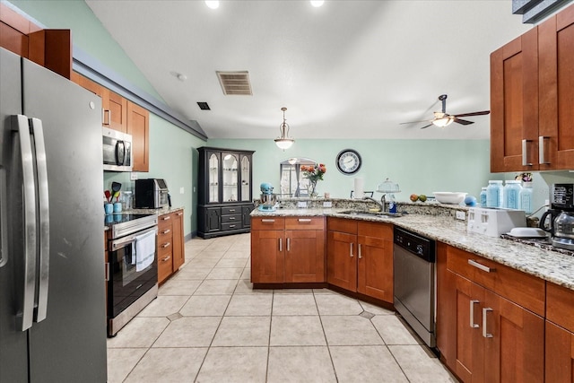 kitchen with light tile patterned floors, visible vents, appliances with stainless steel finishes, a sink, and light stone countertops