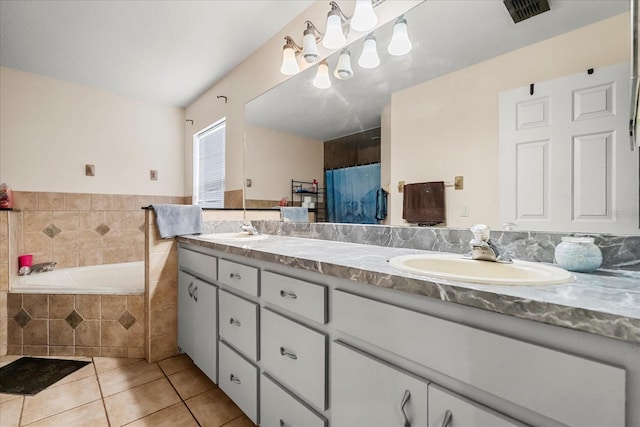 bathroom with double vanity, visible vents, a sink, and tile patterned floors