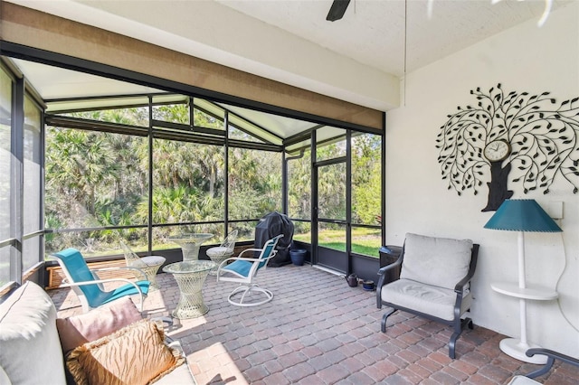 sunroom with vaulted ceiling and ceiling fan