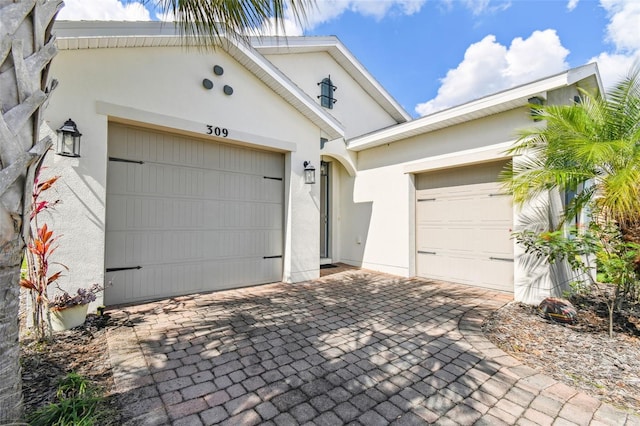 garage with decorative driveway