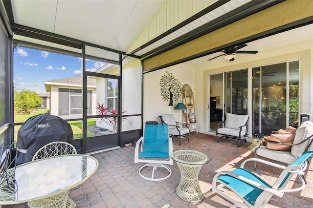 sunroom / solarium with a ceiling fan