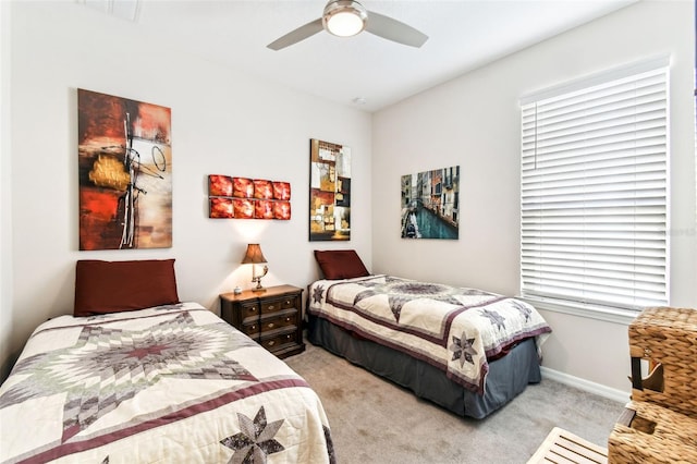 bedroom with a ceiling fan, carpet, and baseboards