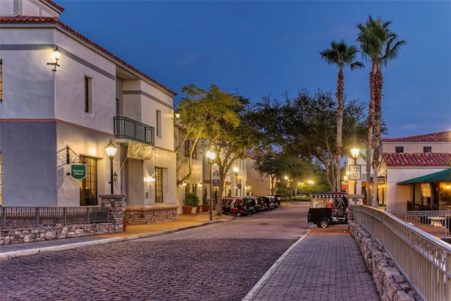 view of street featuring curbs, sidewalks, and street lights