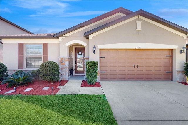 single story home featuring a garage, concrete driveway, stone siding, and stucco siding