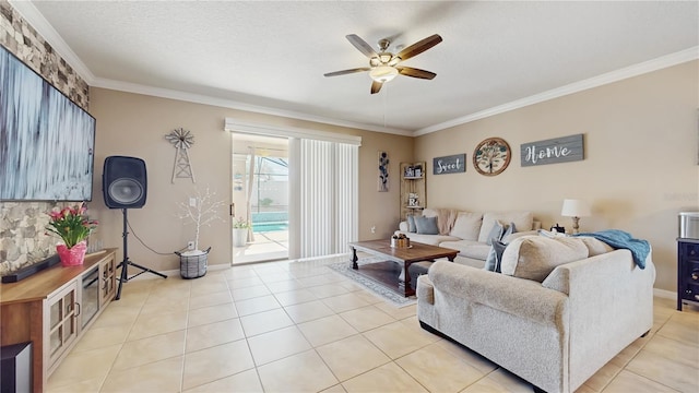 living area with crown molding, light tile patterned floors, a ceiling fan, a textured ceiling, and baseboards