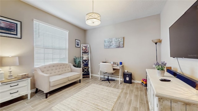 office area featuring baseboards and wood finish floors