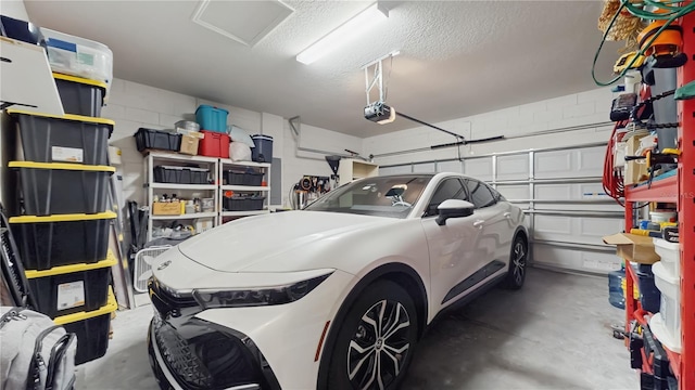 garage with concrete block wall and a garage door opener