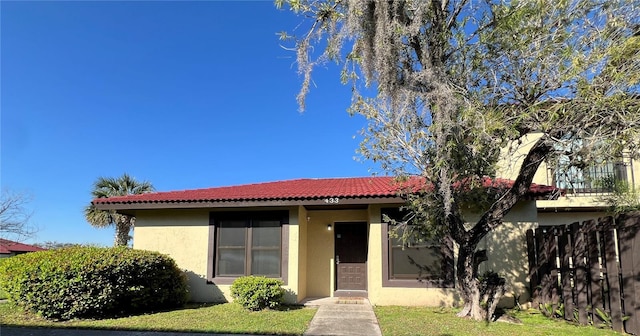 view of front of property with a tile roof and stucco siding