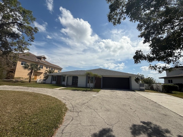 view of front of property with driveway, a front lawn, and an attached garage