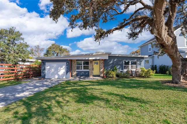 view of front of home with brick siding, an attached garage, fence, driveway, and a front lawn